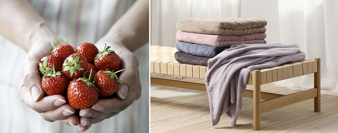 Căpșuni proaspete și un pat de zi cu pături în culorile verii