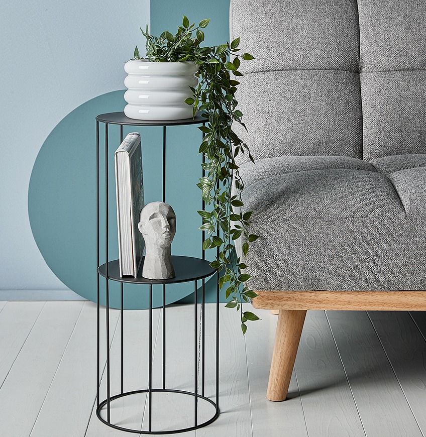 Pedestal with ornament and plant pot with artificial plant 