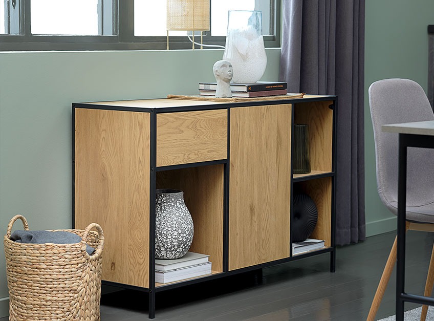 An oak sideboard beneath a window in a dining room