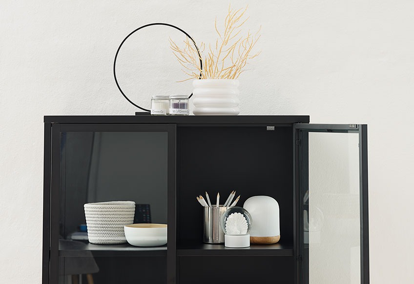 ESGIR tea light holder and TORALF plant pot on top of the VIRUM display cabinet Tea light holder and flowerpot on top of a black display cabinet