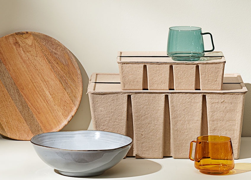 Wooden tray, stoneware bowl, storage boxes out of recycled paper and glass mugs