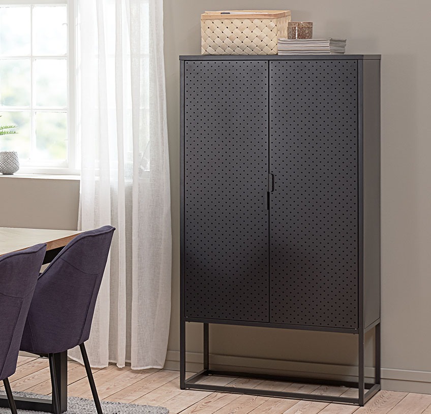 Black cabinet in metal against a wall in a dining room 
