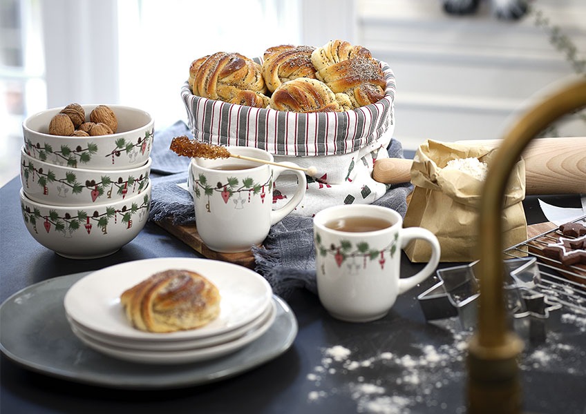 Bowls, mugs and plates with a Christmas print and home baked sweets