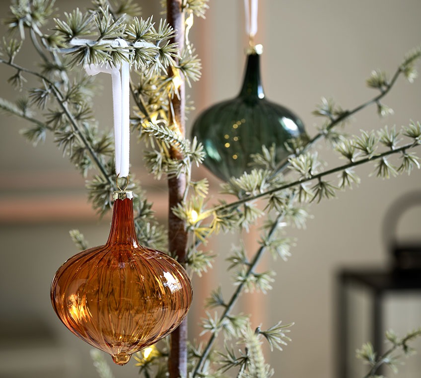 Glass baubles on a slim Christmas tree 