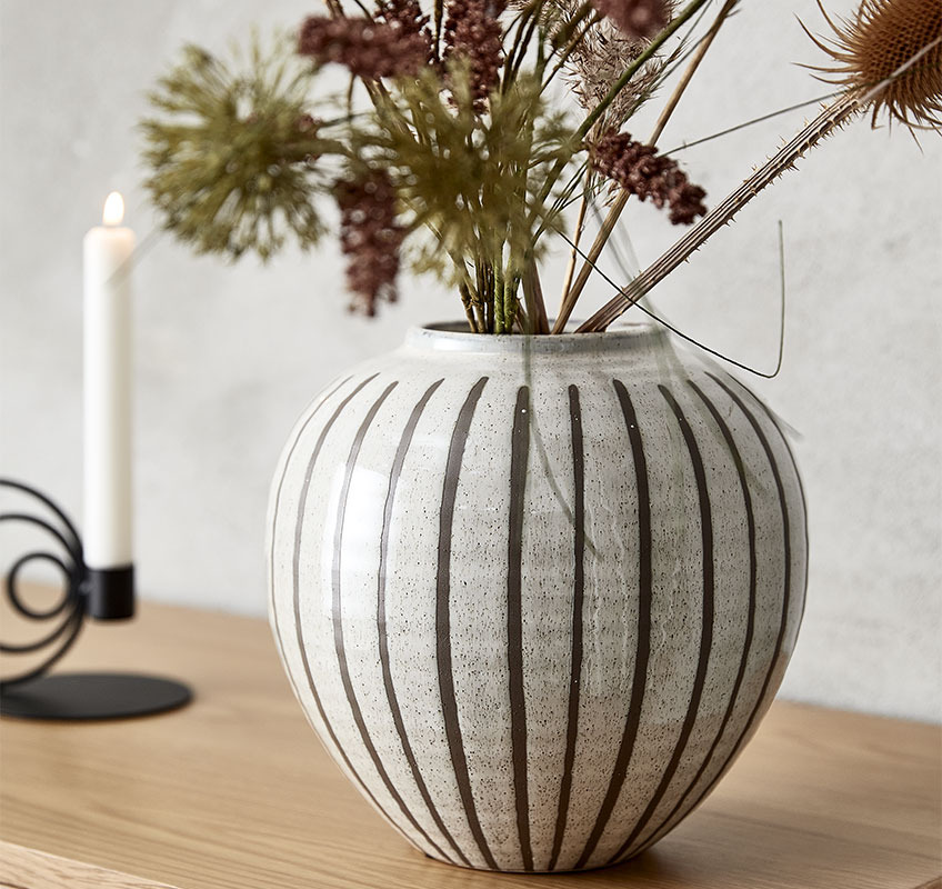 Round, white vase with brown vertical stripes